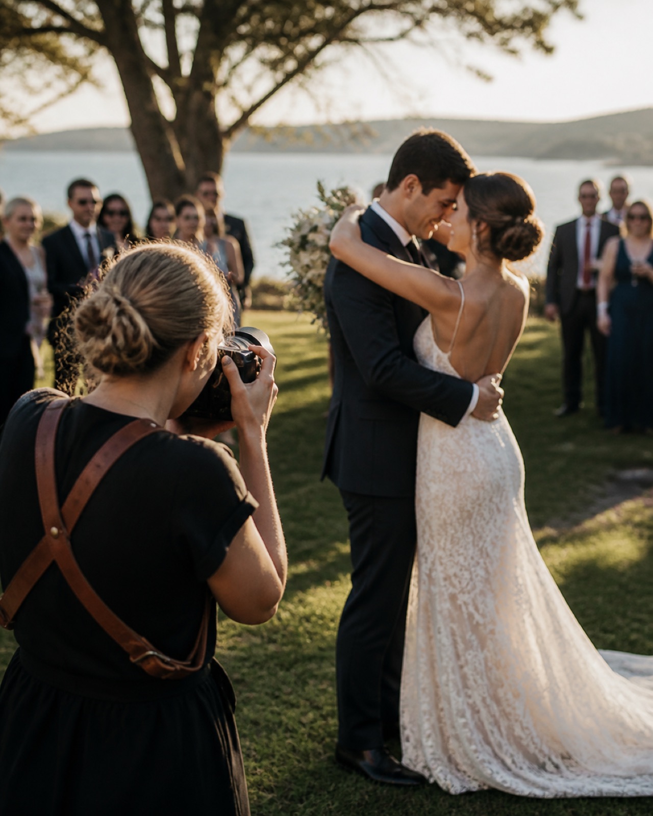 A wedding photographer capturing an intimate candid moment